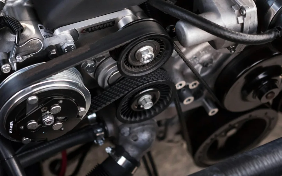 Close-up of a car engine and mechanical components.