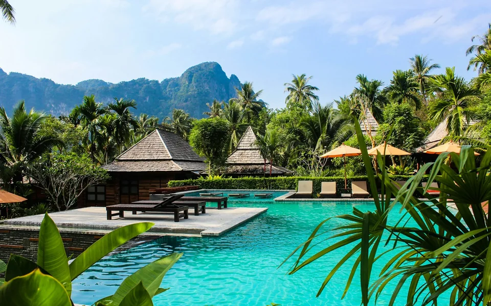 Swimming pool and garden at a tropical resort.