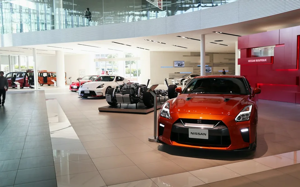 Cars displayed inside a vehicle showroom.